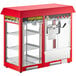 A red and silver Carnival King popcorn machine with glass doors.