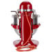 A red and silver KitchenAid commercial countertop mixer with a cord.