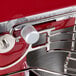 A close up of a red KitchenAid mixer.