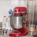 A red and silver KitchenAid mixer on a counter.