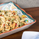 A GET Bella Fresco melamine tray with pasta salad and vegetables on a table.