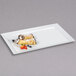 A white rectangular GET Bake and Brew display tray with food on it.