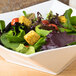 A CAC white porcelain square bowl filled with salad with tomatoes and croutons.