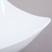 A close-up of a white GET San Michele Flare Bowl with a curved edge.