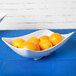 A white GET San Michele melamine bowl filled with oranges.