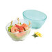 A clear polycarbonate cascading bowl with shrimp and lettuce in it.