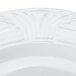 A close up of a CAC Corona white porcelain plate with an embossed design.