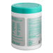 A white container of WipesPlus Lemon Scent Surface Disinfecting Wipes with a green lid.