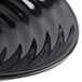 A close-up of a black bowl with a wavy design.