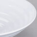 A white melamine bowl with a spiral design.