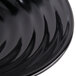 A close-up of a black GET Milano round bowl with a wavy design.