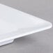 A close up of a white rectangular GET Milano plate.