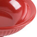 A close up of a red GET Geneva bowl with a small rim.