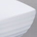 A close up of a white Milano square bowl with a white rim.
