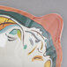 A colorful melamine bowl with a face on it.