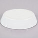 A white oval baker dish with the Hall China logo on the bottom on a gray surface.