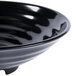 A close-up of a black GET Milano melamine bowl with a curved edge.
