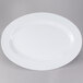 A white oval melamine platter with a white rim.