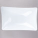 A white rectangular bowl with a curved edge.