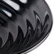 A close-up of a black Milano melamine bowl with a wavy design.