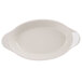 An ivory oval side dish with a white background.