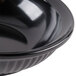 A close-up of a black GET Geneva bowl with a rim.