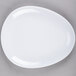 A white oval platter with an egg-shaped pattern.