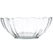 A clear glass bowl with a scalloped edge.