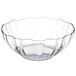 An Arcoroc clear glass bowl with a scalloped edge.