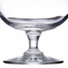 A Libbey Citation brandy glass filled with a clear liquid on a white background.