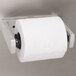 A Bobrick ClassicSeries single roll toilet paper dispenser with a metal handle holding a roll of toilet paper.