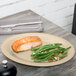 A GET sandstone platter with salmon and green beans on it.