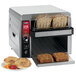 A Waring commercial conveyor toaster with two slices of bread in it.