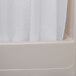 An Oxford white 100% polyester shower curtain hanging in a bathtub.