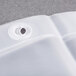 A close up of a Bobrick white vinyl liner with a hole in it.