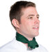 A man in a chef's uniform wearing a hunter green chef neckerchief.
