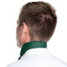The back of a man wearing a hunter green chef neckerchief tied around his neck.