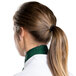A woman wearing a hunter green Intedge chef neckerchief with a ponytail.