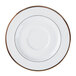 A bright white porcelain saucer with a white rim and gold accents.