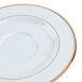 A CAC Golden Royal bright white porcelain saucer with a gold rim.
