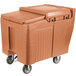 A large brown plastic Cambro mobile ice bin with wheels.