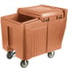 A Cambro brown plastic mobile ice bin with a sliding lid.