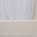 A white Oxford shower curtain with a sheer voile window panel hanging in a bathtub.
