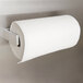 A Bobrick paper towel roll holder with a roll of paper towels on it.