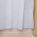 An Oxford white shower curtain with a sheer voile window and removable liner on a white bathtub.