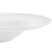 A close-up of a CAC Paris bone white porcelain soup bowl with a rim.