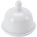 A bright white porcelain butter dish with a lid on a white surface.