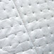 A close-up of a Spilfyter white oil absorbent pad with holes.