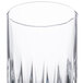 A close up of a Libbey Winchester highball glass with a curved edge and pattern.