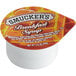 A white Smucker's breakfast syrup portion cup with a red and white label.